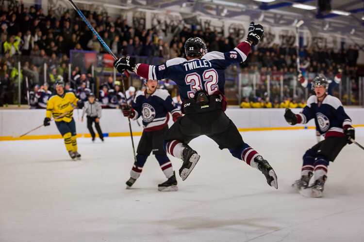 An underexposed hockey image where the ice has turned a shade of gray - Tips for Editing Hockey Photos in Lightroom