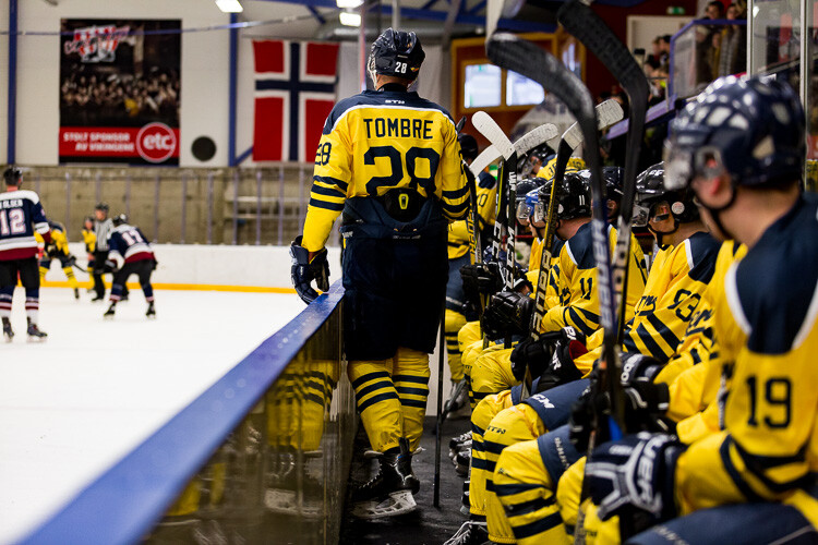 A hockey player on the bench, with a pinch of clarity applied - Tips for Editing Hockey Photos in Lightroom