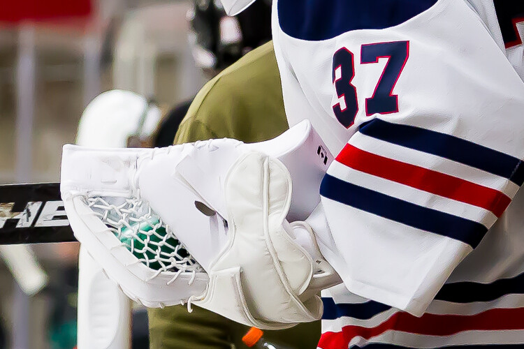 Examples of sharpening and noise reduction in a hockey image
