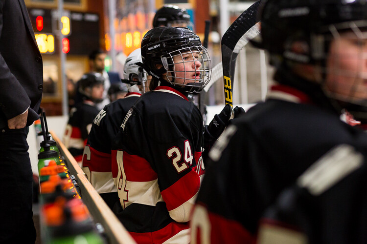 A hockey player on the bench during a game - Tips for Editing Hockey Photos in Lightroom