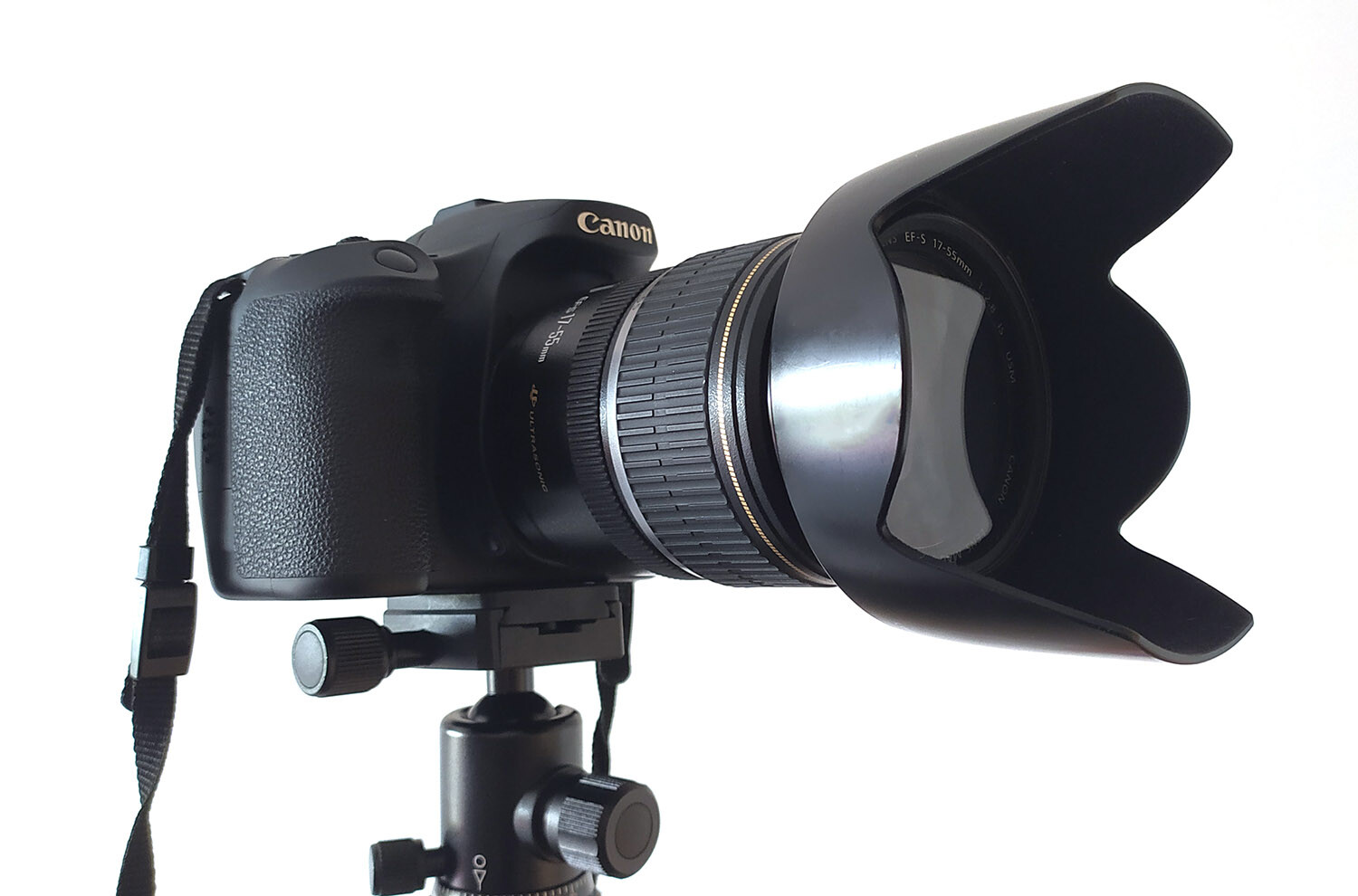 Canon camera on a tripod with a lens hood