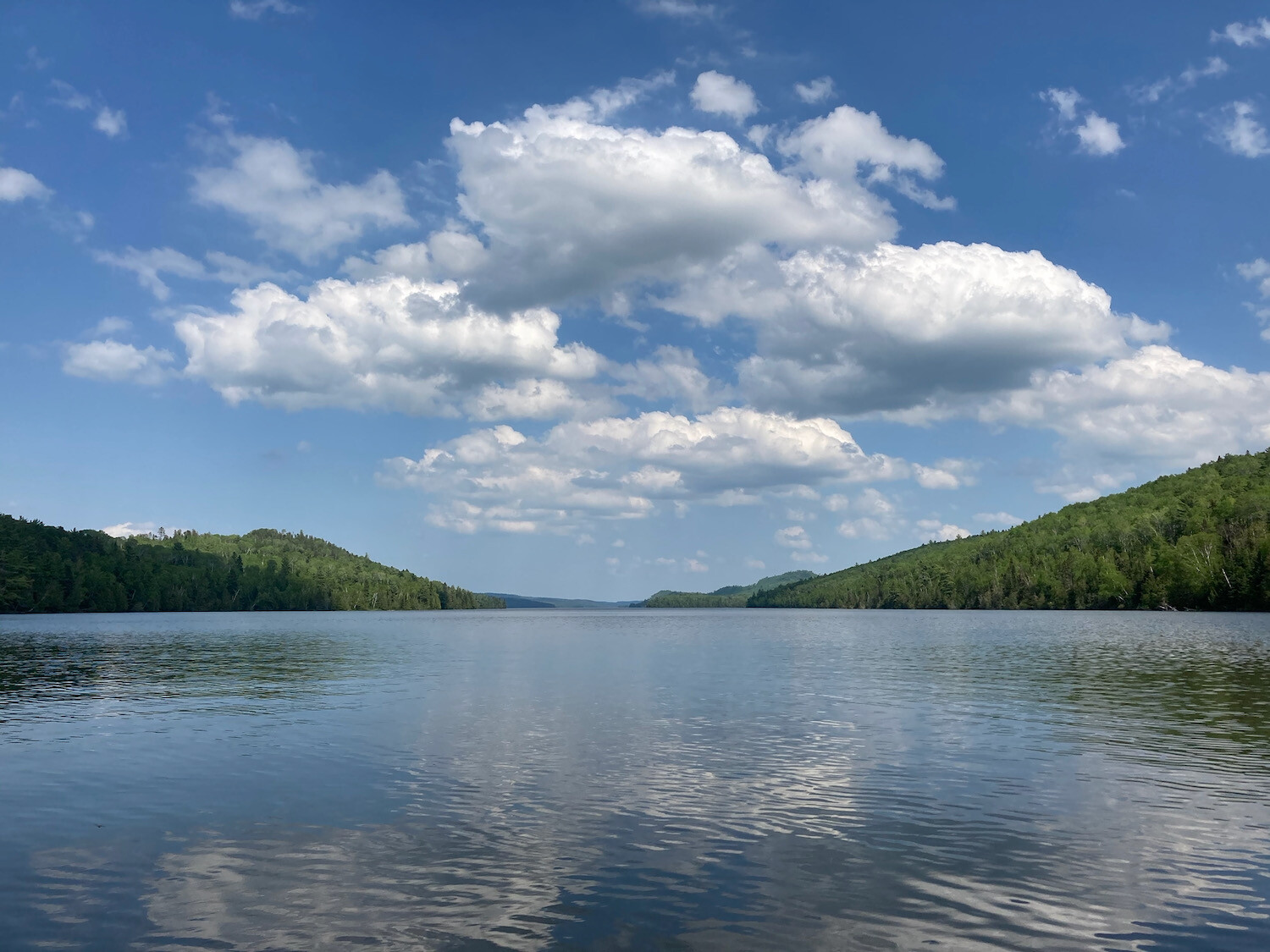 lake with fluffy clouds